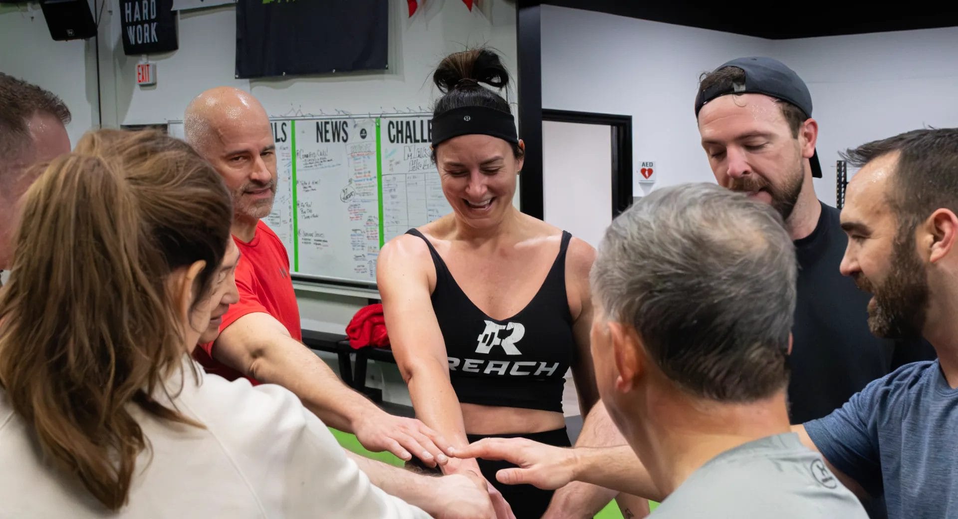 Members with coach at REACH Fitness